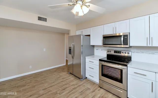 a kitchen with stainless steel appliances a stove microwave and refrigerator
