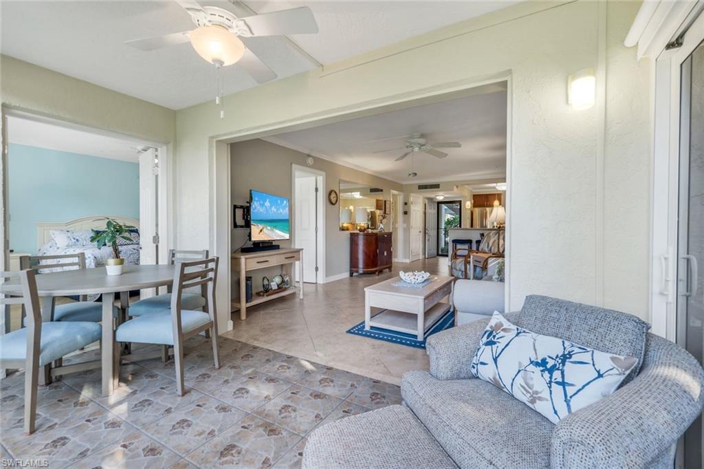 201 Quail Forest Boulevard, Unit 101 Naples, FL 34105 - Photo 10 of 32 a living room with furniture and a wooden floor