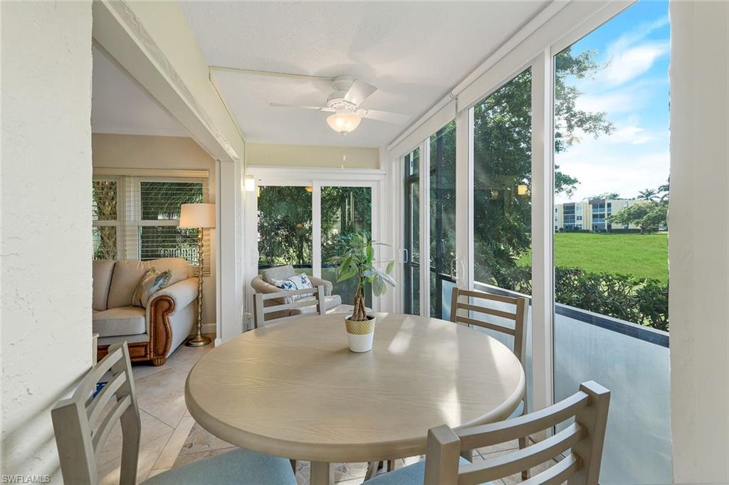 201 Quail Forest Boulevard, Unit 101 Naples, FL 34105 - Photo 11 of 32 a dining room with furniture water view and balcony