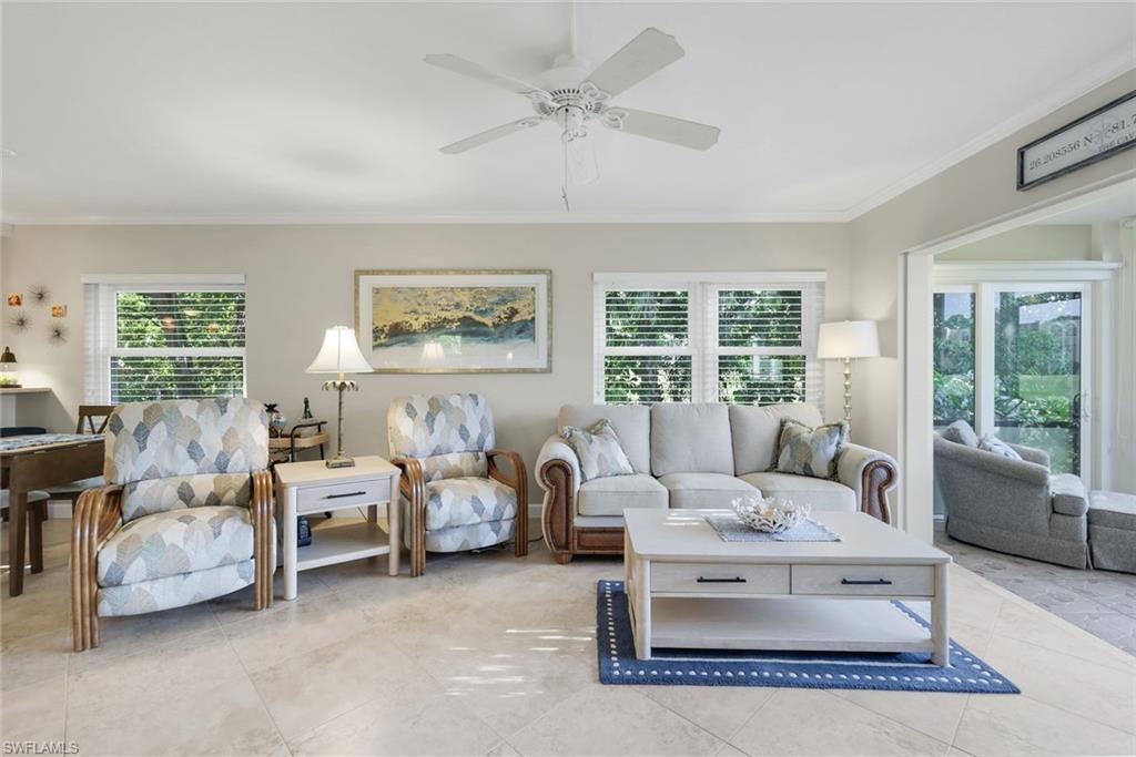 201 Quail Forest Boulevard, Unit 101 Naples, FL 34105 - Photo 12 of 32 a living room with furniture and a large window