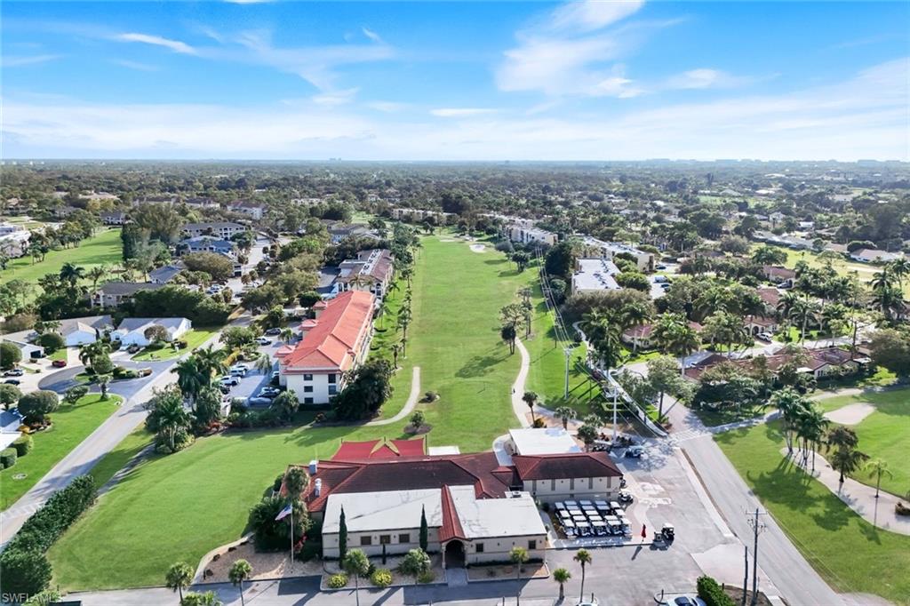201 Quail Forest Boulevard, Unit 101 Naples, FL 34105 - Photo 28 of 32 an aerial view of residential houses and lake