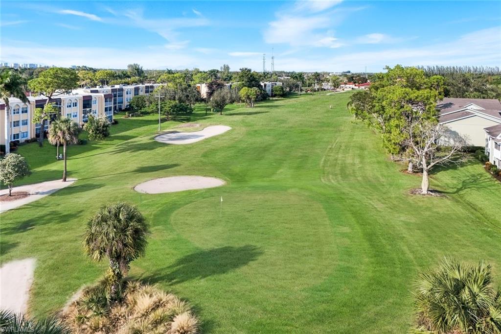 201 Quail Forest Boulevard, Unit 101 Naples, FL 34105 - Photo 30 of 32 a view of a golf course with a garden