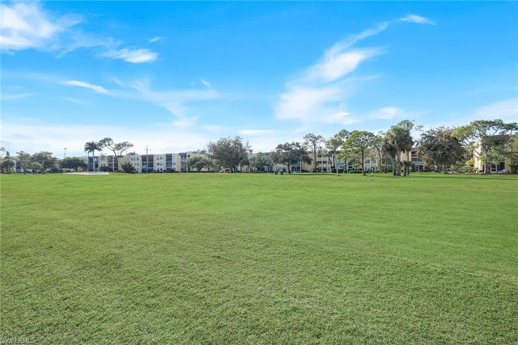 201 Quail Forest Boulevard, Unit 101 Naples, FL 34105 - Photo 9 of 32 a view of a green field with clear sky
