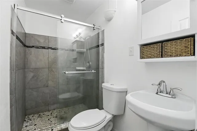 a bathroom with a sink toilet and shower