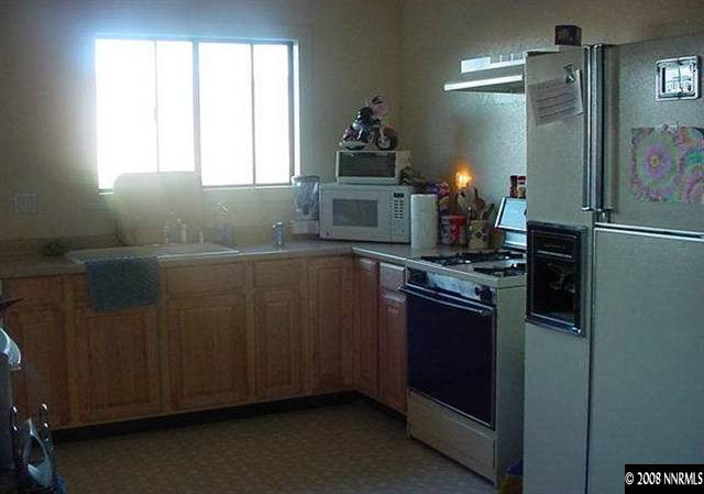 1000 Ironwood Road Reno, NV 89510 - Photo 3 of 4 a kitchen with stainless steel appliances granite countertop a refrigerator and a stove