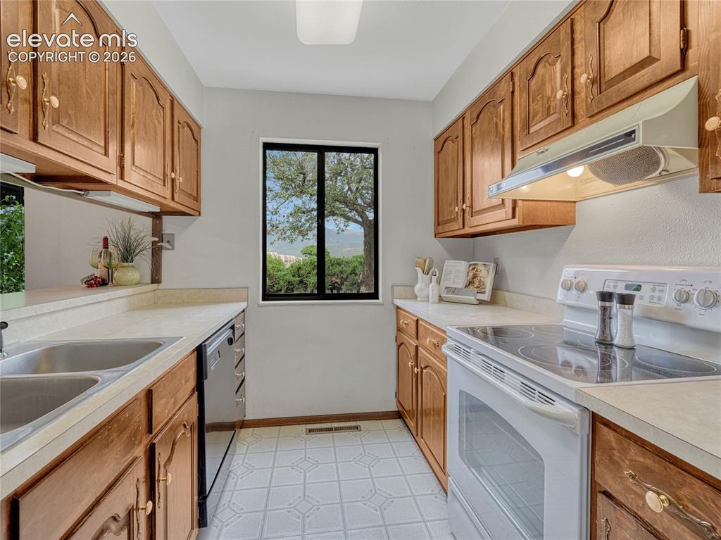 1146 Fontmore Road, Unit A Colorado Springs, CO 80904 - Photo 3 of 24 a kitchen with stainless steel appliances granite countertop a sink stove and cabinets
