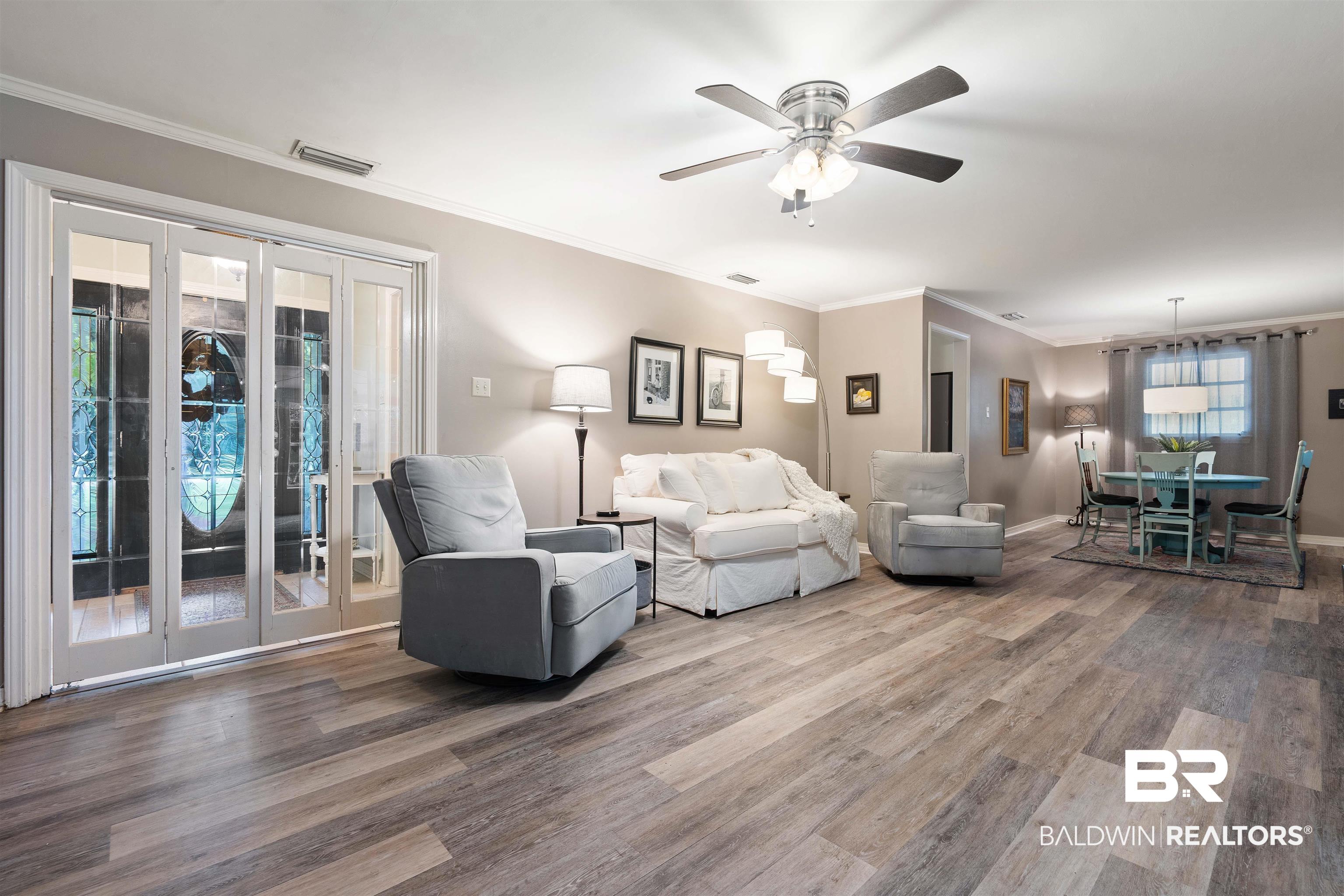 4051 East Canal Circle Mobile, AL 36619 - Photo 7 of 32 Living room with crown molding, french doors, ceiling fan, and hardwood / wood-style floors