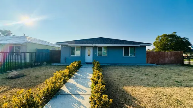 a view of a house with wooden fence