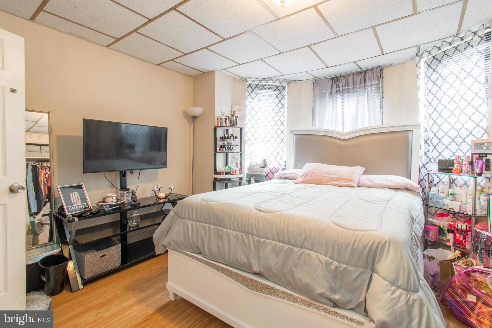3317 Malta Street Philadelphia, PA 19134 - Photo 13 of 17 a bedroom with a bed and a flat screen tv