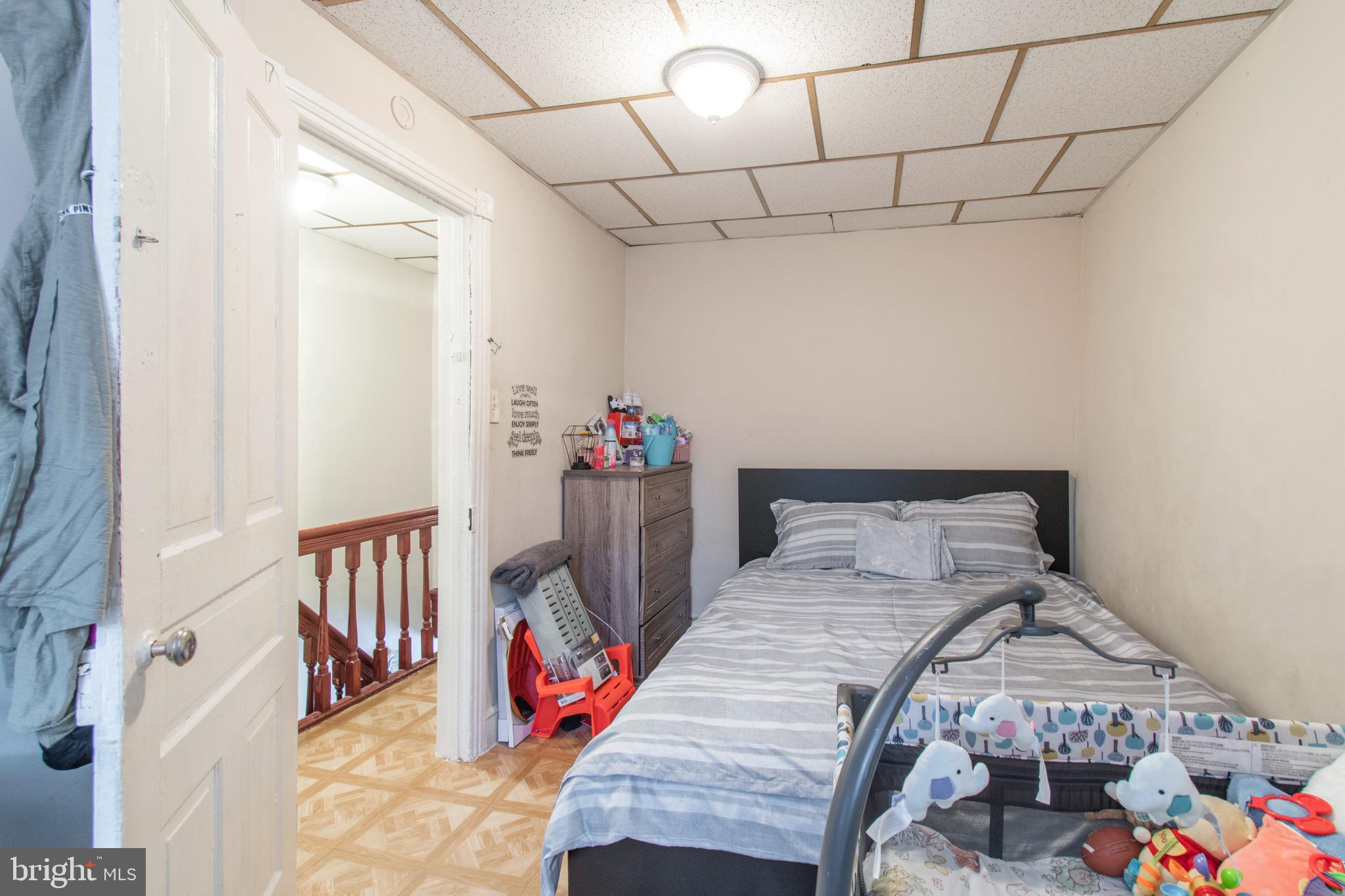 3317 Malta Street Philadelphia, PA 19134 - Photo 15 of 17 a bedroom with a bed and a table