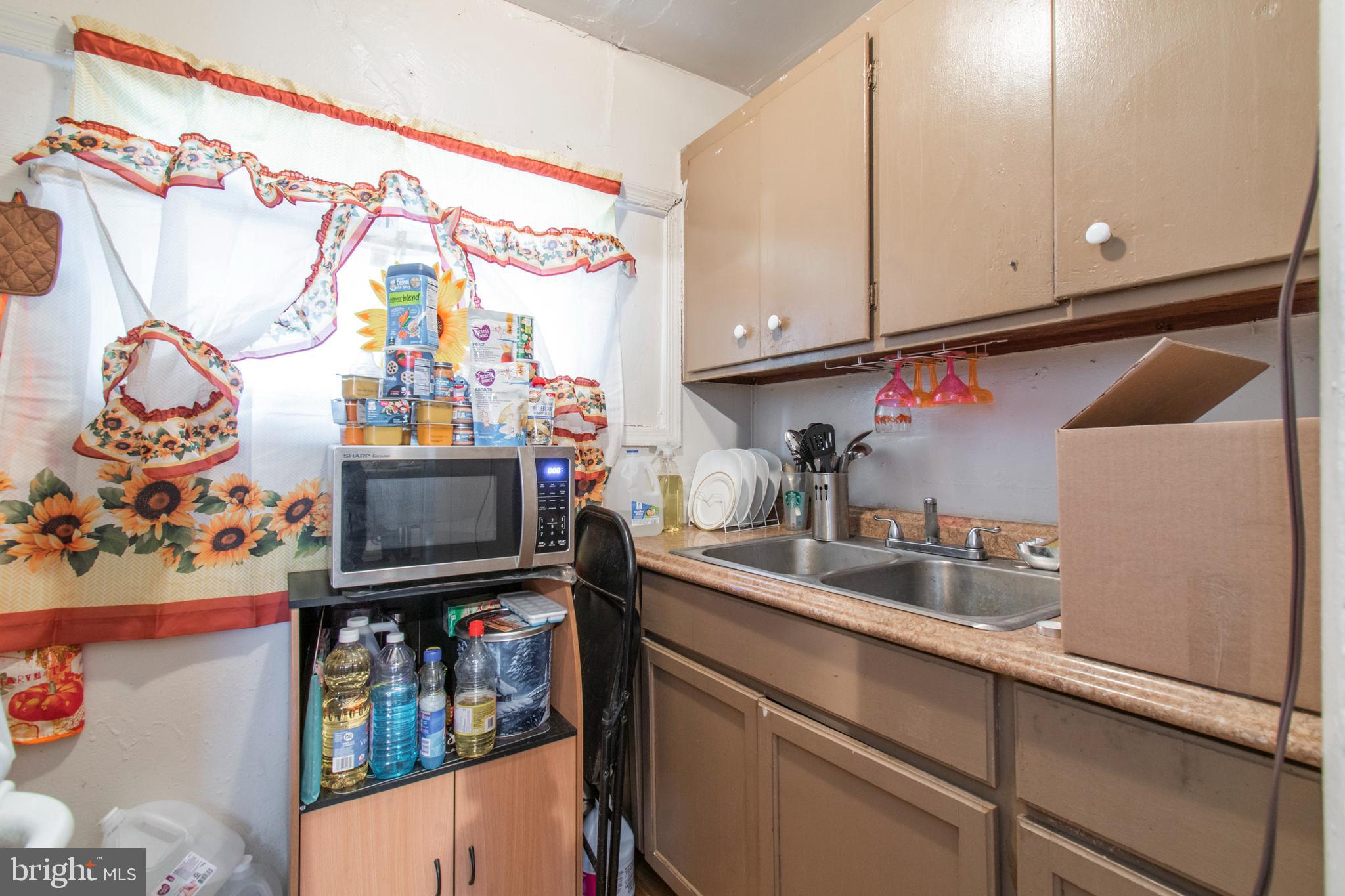 3317 Malta Street Philadelphia, PA 19134 - Photo 10 of 17 a kitchen with stainless steel appliances granite countertop a sink and a microwave
