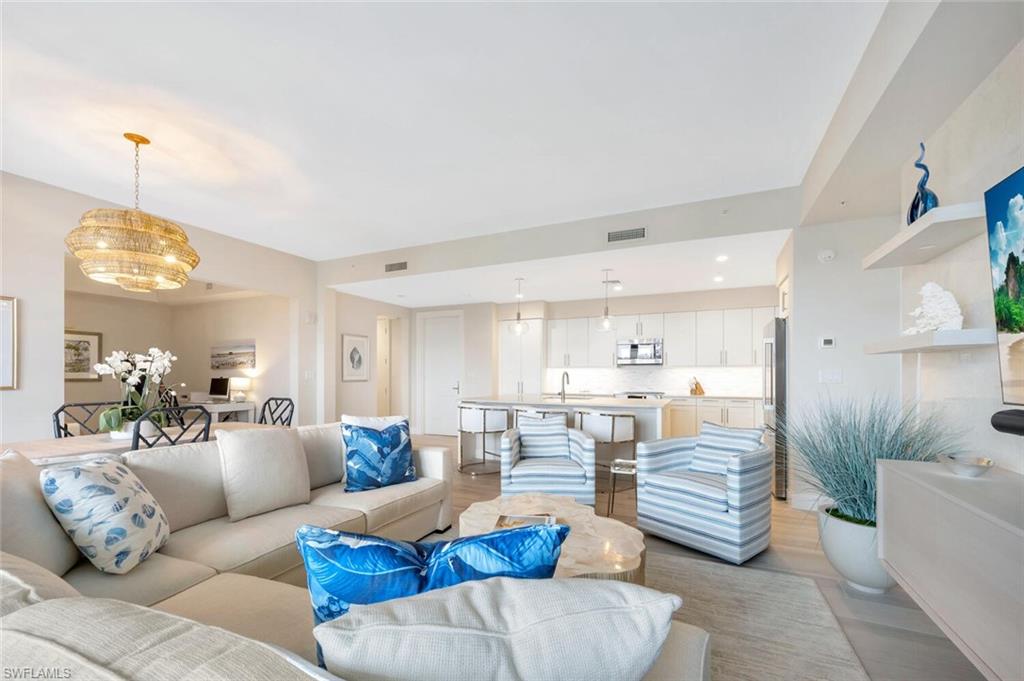 1111 Central Avenue, Unit 511 Naples, FL 34102 - Photo 11 of 50 a living room with furniture and a chandelier