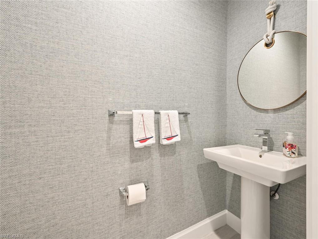 1111 Central Avenue, Unit 511 Naples, FL 34102 - Photo 19 of 50 a bathroom with a sink and a mirror