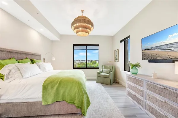 a bedroom with a bed and windows