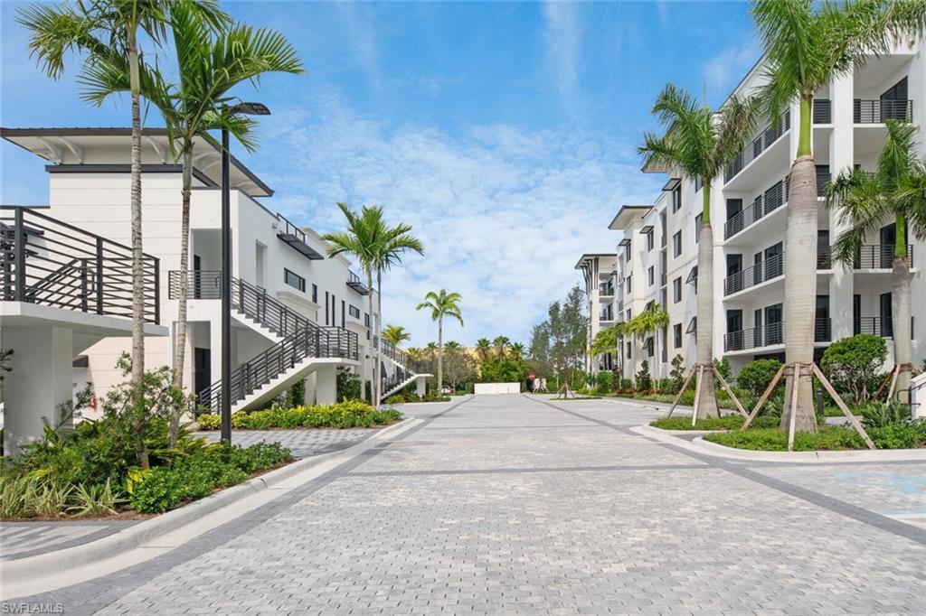 1111 Central Avenue, Unit 511 Naples, FL 34102 - Photo 2 of 50 a view of a palm trees in front of a building