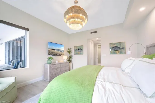 a bedroom with a bed and a large window