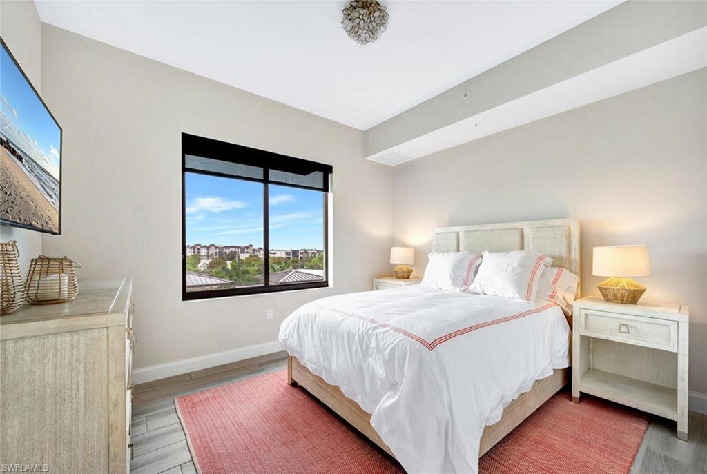 1111 Central Avenue, Unit 511 Naples, FL 34102 - Photo 26 of 50 a bedroom with a bed and a window