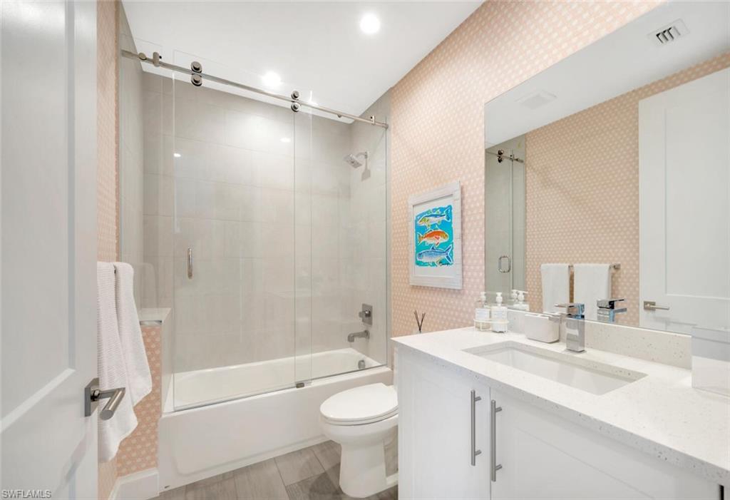 1111 Central Avenue, Unit 511 Naples, FL 34102 - Photo 28 of 50 a bathroom with a sink a toilet and shower