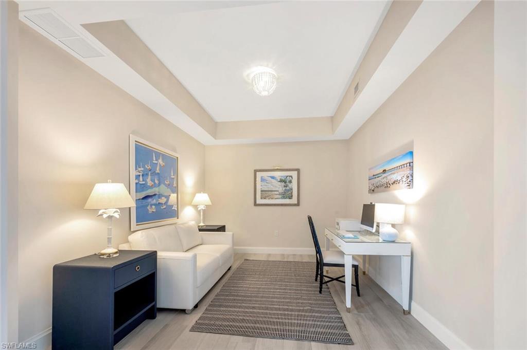 1111 Central Avenue, Unit 511 Naples, FL 34102 - Photo 29 of 50 a room with a bed and a table in it