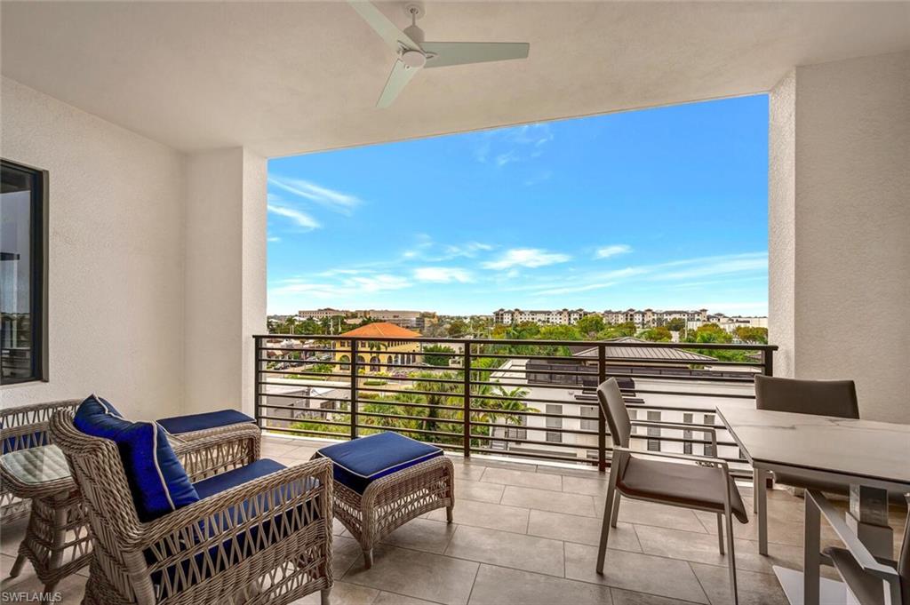 1111 Central Avenue, Unit 511 Naples, FL 34102 - Photo 32 of 50 a view of a balcony with furniture and a floor to ceiling window