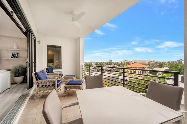 a view of a living room with furniture and a floor to ceiling window