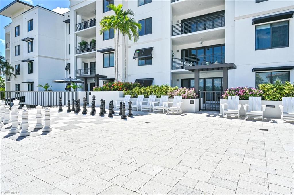 1111 Central Avenue, Unit 511 Naples, FL 34102 - Photo 38 of 50 a view of a building with a bench in patio
