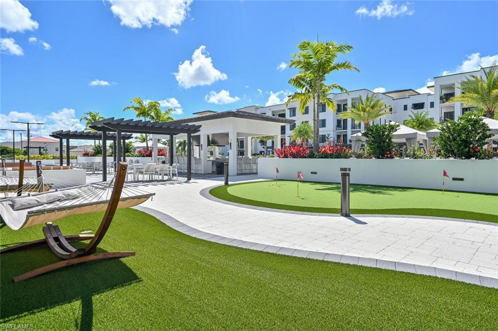 1111 Central Avenue, Unit 511 Naples, FL 34102 - Photo 39 of 50 a swimming pool with outdoor seating and yard