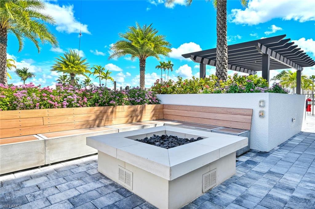 1111 Central Avenue, Unit 511 Naples, FL 34102 - Photo 41 of 50 a white building with a outdoor seating and a yard