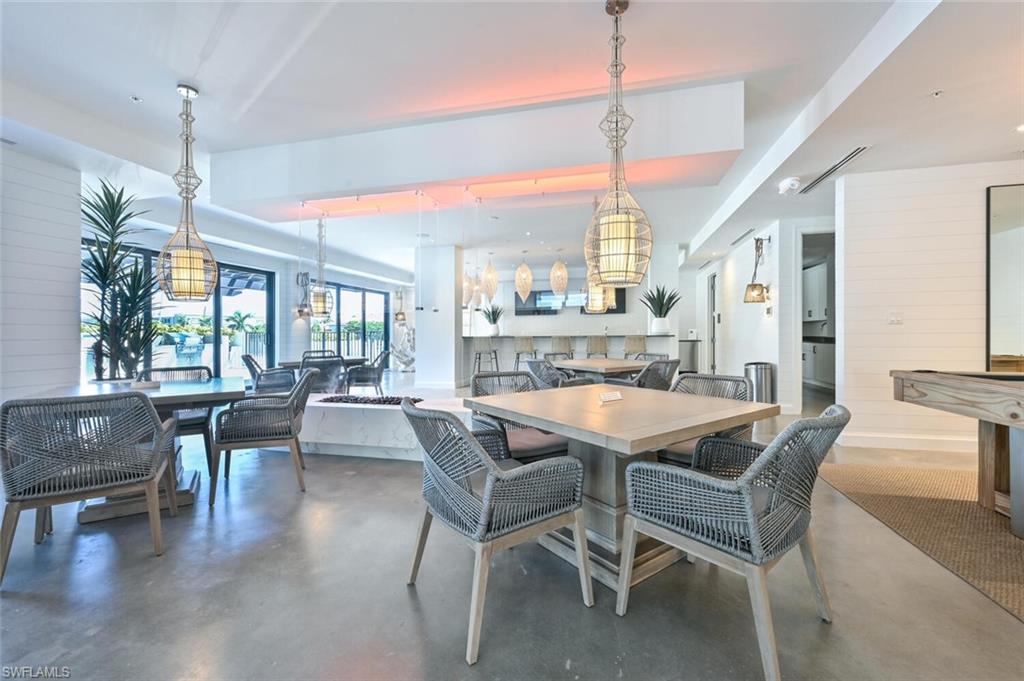 1111 Central Avenue, Unit 511 Naples, FL 34102 - Photo 43 of 50 a dining room with furniture window wooden floor