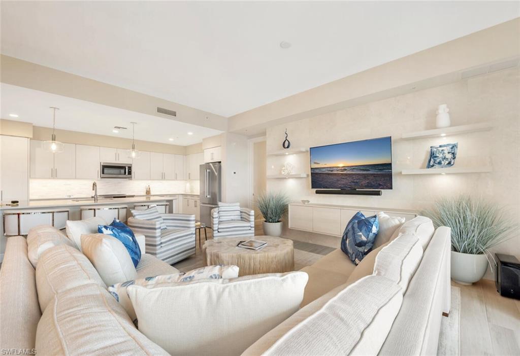 1111 Central Avenue, Unit 511 Naples, FL 34102 - Photo 10 of 50 a living room with furniture and a flat screen tv