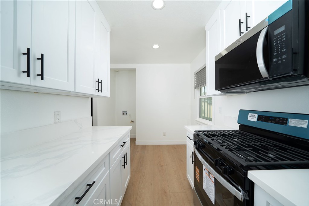 1048 Cedar Avenue Long Beach, CA 90813 - Photo 7 of 7 a kitchen with stainless steel appliances a stove microwave and sink