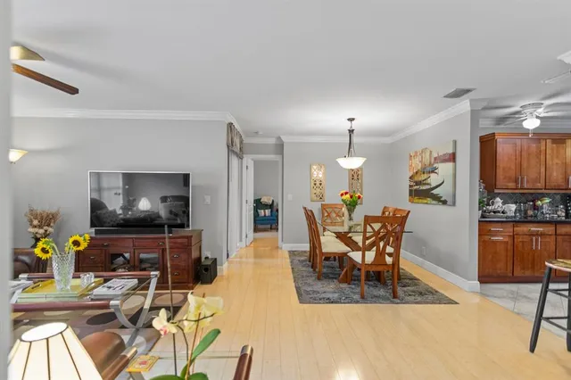 a view of a dining room with furniture and chandelier