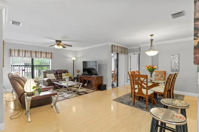 a view of a dining room with furniture and wooden floor