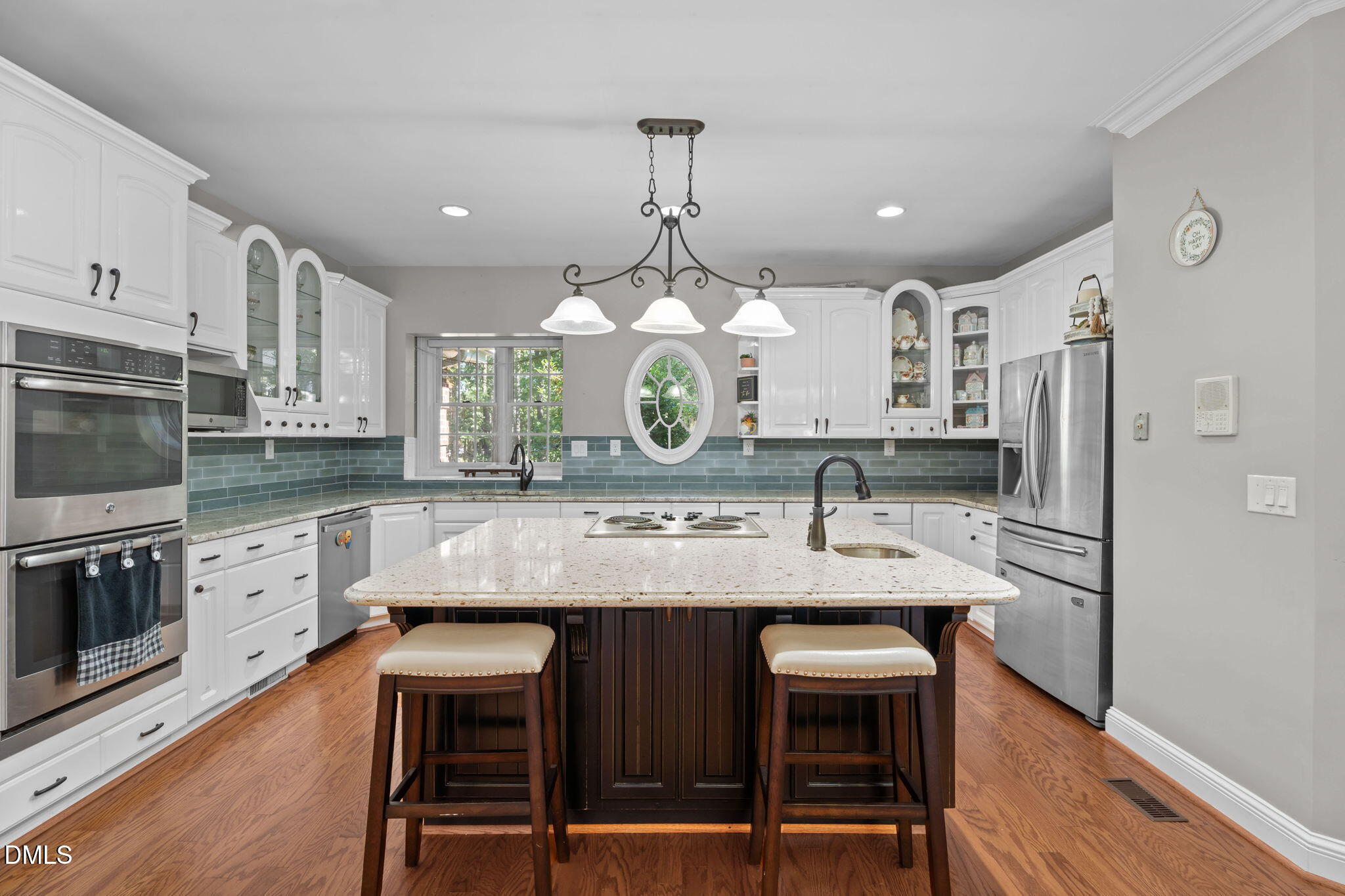 5870 Hoyt Road Middlesex, NC 27557 - Photo 12 of 33 a kitchen with kitchen island granite countertop a table chairs stove and refrigerator