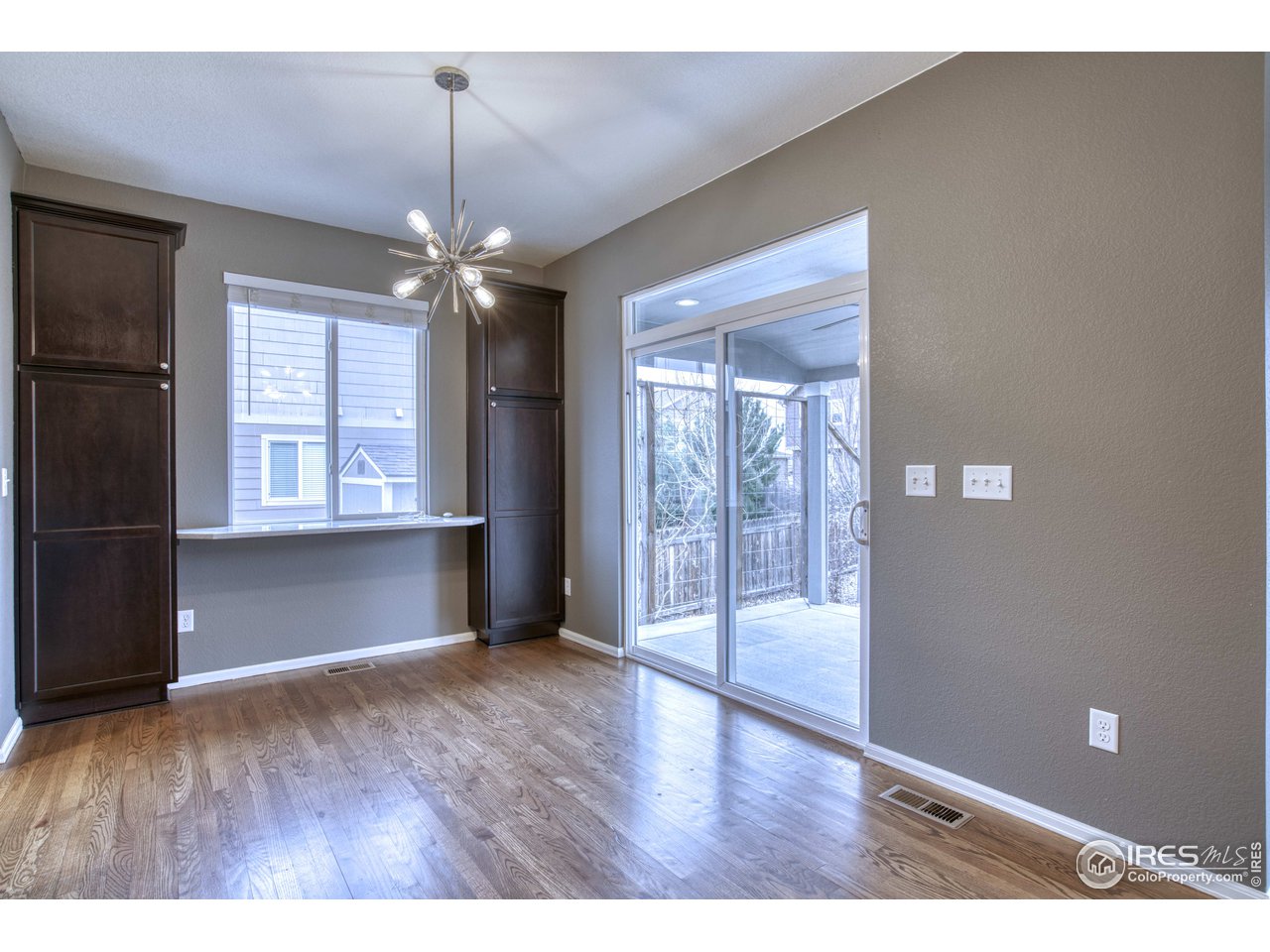 8552 Raspberry Drive Frederick, CO 80504 - Photo 11 of 40 a view of an empty room with window and wooden floor