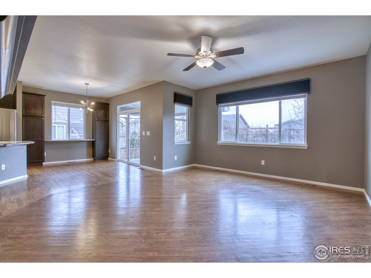 8552 Raspberry Drive Frederick, CO 80504 - Photo 12 of 40 a view of an empty room with wooden floor and a window