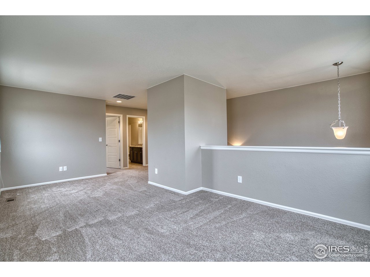 8552 Raspberry Drive Frederick, CO 80504 - Photo 23 of 40 a view of an empty room with window and stairs