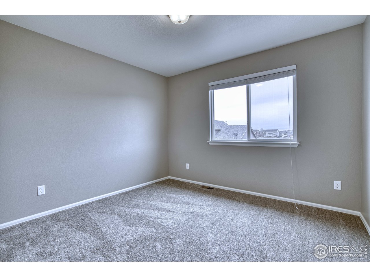 8552 Raspberry Drive Frederick, CO 80504 - Photo 27 of 40 a view of an empty room with a window