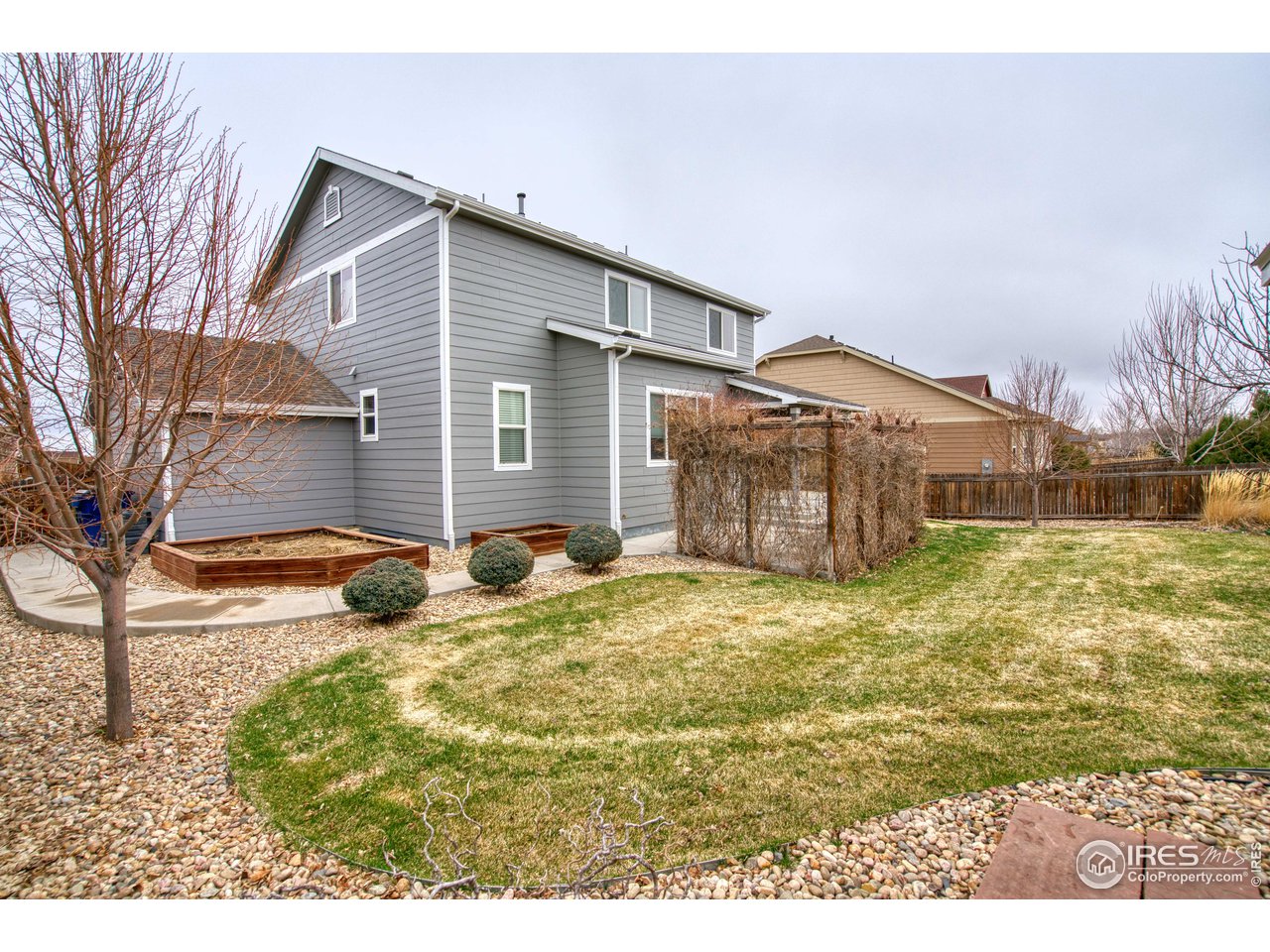8552 Raspberry Drive Frederick, CO 80504 - Photo 37 of 40 a view of a house with a yard covered in snow