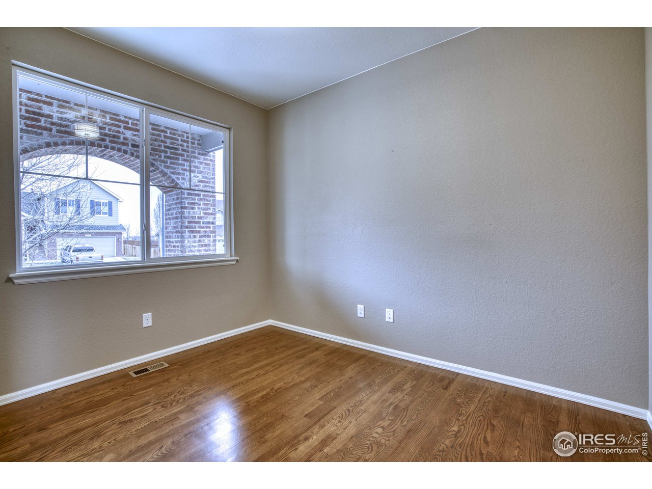 8552 Raspberry Drive Frederick, CO 80504 - Photo 5 of 40 a view of an empty room with wooden floor and a window