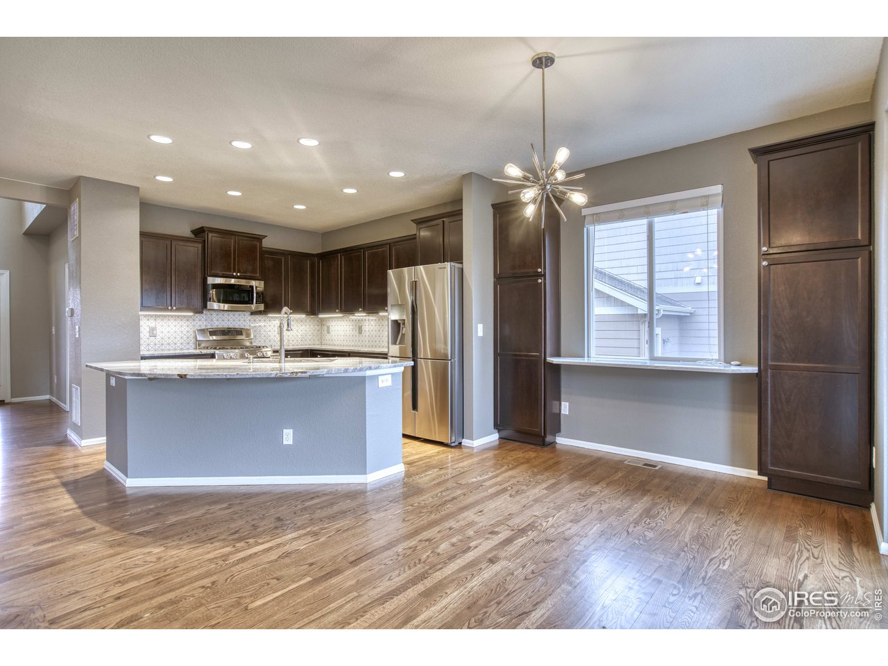 8552 Raspberry Drive Frederick, CO 80504 - Photo 6 of 40 a view of kitchen with kitchen island granite countertop cabinets and refrigerator