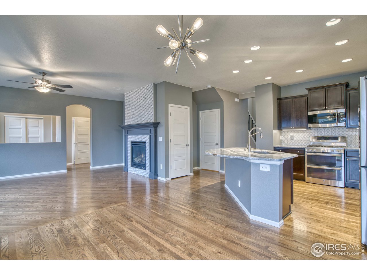8552 Raspberry Drive Frederick, CO 80504 - Photo 10 of 40 a kitchen with stainless steel appliances granite countertop a refrigerator a sink a stove and a microwave