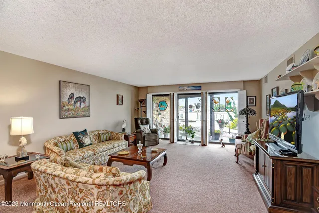 a view of a dining room with furniture and chandelier
