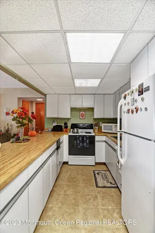 a kitchen with stainless steel appliances kitchen island granite countertop a sink stove and cabinets