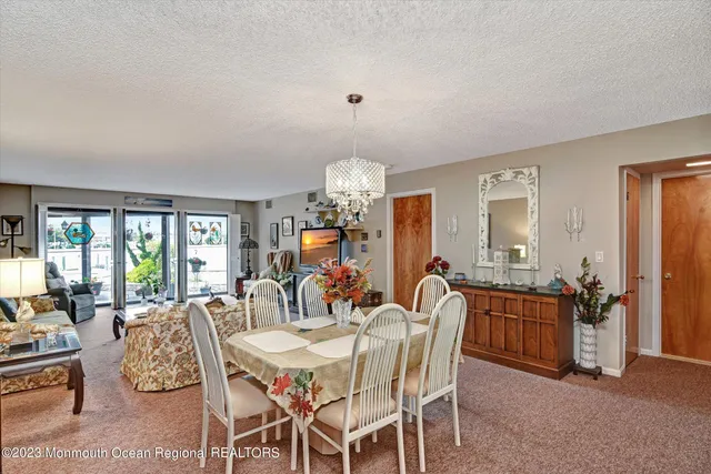 a living room with furniture large window and a flat screen tv
