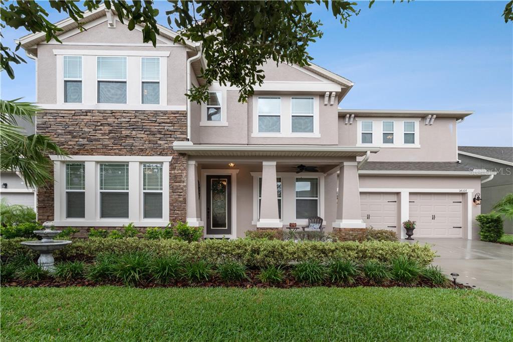 14107 Magnolia Ridge Loop Winter Garden, FL 34787 - Photo 1 of 1 a front view of a house with a yard and trees