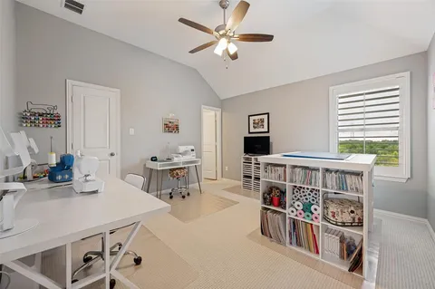 a living room with furniture a flat screen tv and a window