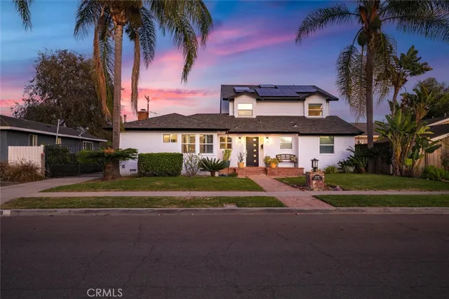 a front view of a house with swimming pool having outdoor seating