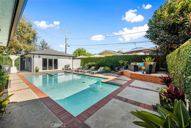 swimming pool view with sitting space and garden view