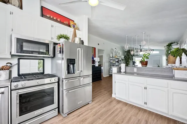 a kitchen with stainless steel appliances a stove microwave and cabinets